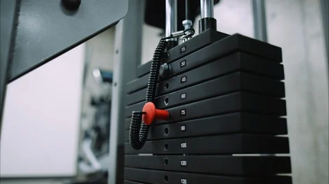 Close view of lat pull weight stack rising and falling during workout Video stock 126670556