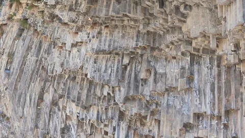 Close-up view of layered cliff with columnar rock formations Stock Footage 341776208