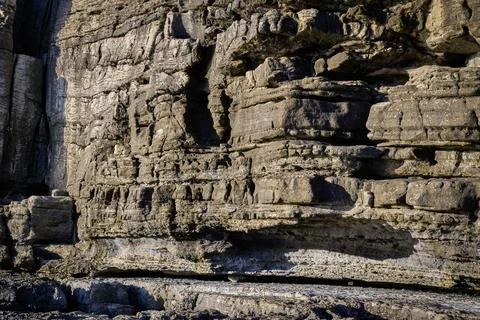 Close view of layers of eroded rocks on sunny day, Portugal Stock Photos