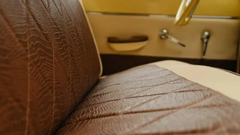 Close up view of leather seats in old retro vintage car in brown and beige Stock Footage 156699018