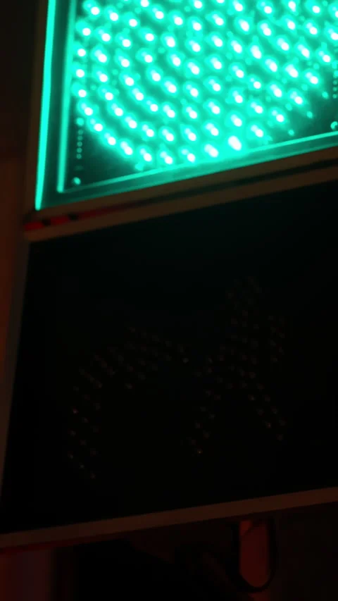 Close-up view of LED pedestrian crossing signal transitioning from unlit to Stock Footage 329555507