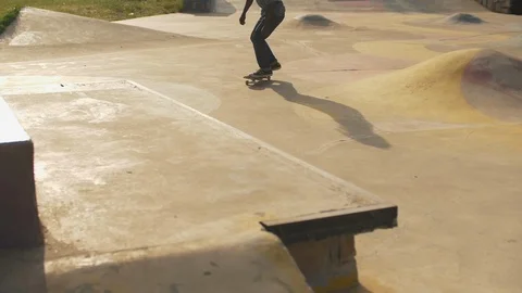 Close up view legs jumping on the grind box in the skatepark slow motion Stock Footage 112986422