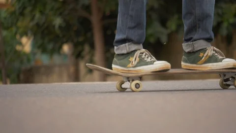 Close up view legs of young boy riding on skateboard  Stock Footage 113003774
