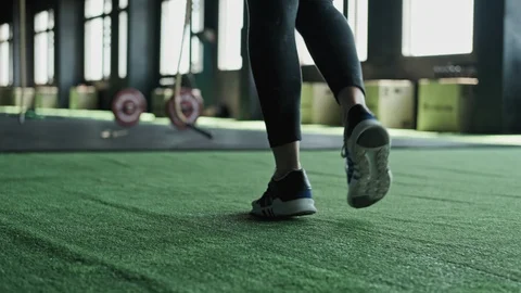 Close-up view of legs of young fit woman entering fitness club. Tracking shot Video stock 109953373