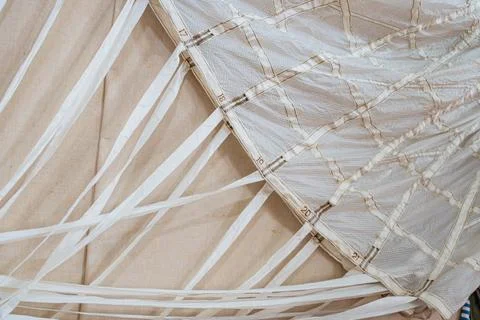 Close-up view of a light-colored mesh section, possibly netted parachute comp 스톡 사진