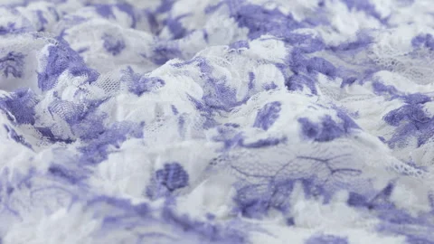 Close-up view of the light textured lace fabric in white and blue tones. Video stock 290769906