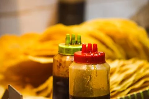 Close Up View of Liquid Palm Sugar Sauce Bottles placed in front of Lempeng.. Stock Photos