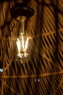 Close up view of a lit light bulb making a warm light. Energy crisis concept Stock Photos