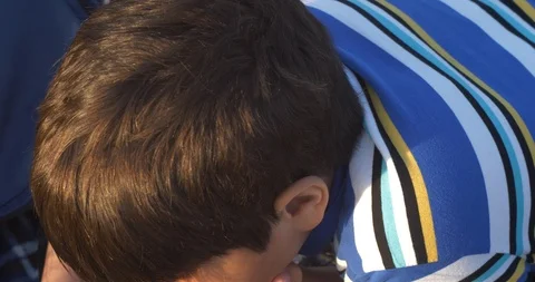 Close up view of little boy is lying on carpet in nature with cell phone in Video stock 90801001