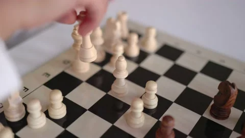 Close-up view of little hands moving a chess figure on chessboard Stock Footage 194335791