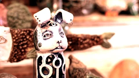 Close up view of little rabbit statuette with three eyes and long ears standing Vídeos de archivo 116378545
