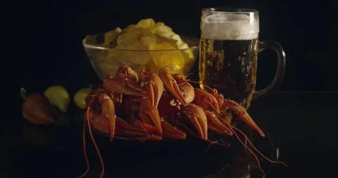 Close up view of lobsters with foamy bear and chips on background in slow motion Stock Footage 142735894