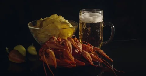 Close up view of lobsters with foamy bear and chips on background in slow motion Stock Footage 142735918