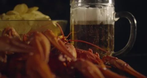 Close up view of lobsters with foamy bear and chips on background in slow motion Stock Footage 142735951
