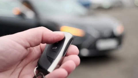 Close up view of locking and unlocking car with key remotely. car key in his Stock Footage 171777034
