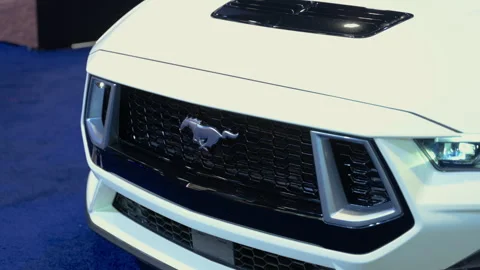 Close up view of logo 2026 Ford Mustang GT sports car showcased at auto show Stock Footage 330987260