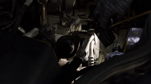 Close up view of looking for breakdown in engine with flashlight. Maintenance of Stock Footage 201965012