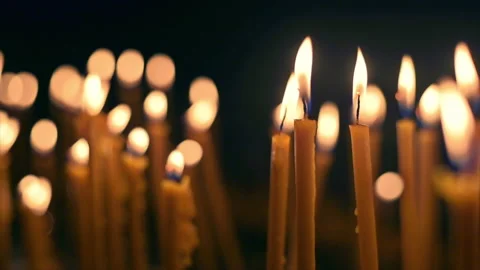 Close view of lots of burning candles with black background. Slow motion Stock Footage 201150606