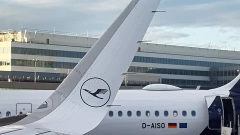 Close view of a Lufthansa airplane tail and parked aircraft at Frankfurt Stock Footage 339909693