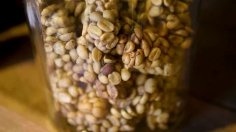 Close up view of luwak coffee beans in jar Stock Footage 333114120