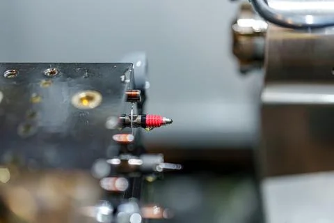 Close view of a machine part showing a red component next to metal componen.. Stock Photos
