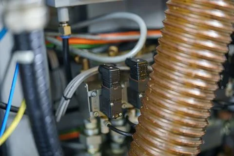 Close view of machinery components showing sensors and hoses in a mechanica.. Stock-Fotos