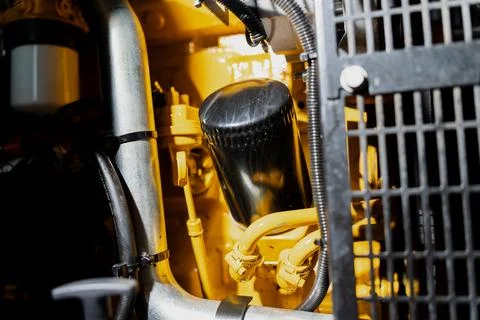 Close view of machinery engine bay featuring oil filter housing Foto stock