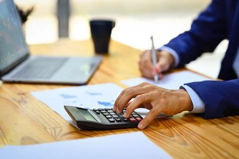 Close up view of male analyst using calculator, checking marketing research Stock Photos