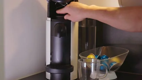 Close up view of male hand loading capsule in coffee machine. Stock Footage 145689903