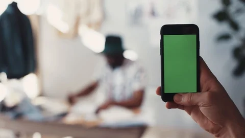 Close up view of a male hand using cell-phone and taking photo of a working Stock Footage 87028334