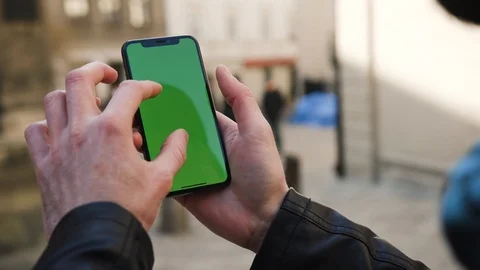 Close up view of male hand using smartphone with green screen in vertical Stock Footage 104897767