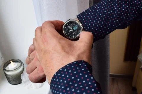 Close up view of male hands checking time Stock Photos