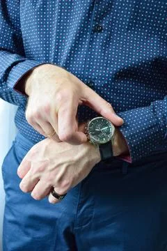 Close up view of male hands checking time on luxury wristwatch 스톡 사진