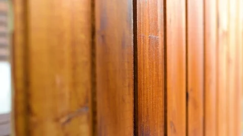 Close-up view of male hands paiting wooden surface with wood stain Stockbeeldmateriaal 149701706