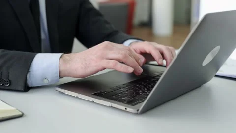 Close-up view of male hands typing on laptop keyboard. Caucasian businessman Stock Footage 195127095