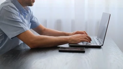 Close-up view of male hands typing on a laptop Video stock 247521240