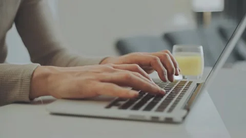 Close up view of male hands typing on laptop keyboard in bright office space. Stock Footage 337419224