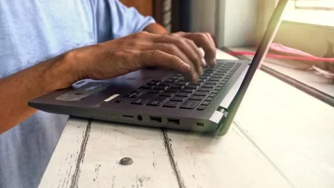 A close up view of male hands typing on a laptop computer keyboard while wo.. Vídeo Stock 345139884