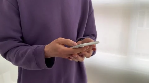 Close up view of male hands using smartphone scrolling, browsing, surfing Stock Footage 241333536