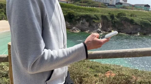 Close up view of male hands using smartphone scrolling, browsing, surfing Stock Footage 241525353