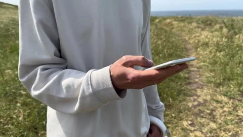 Close up view of male hands using smartphone scrolling, browsing, surfing Stock Footage 241663697