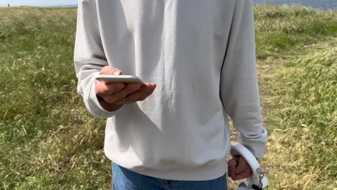 Close up view of male hands using smartphone scrolling, browsing, surfing Stock Footage 241995522