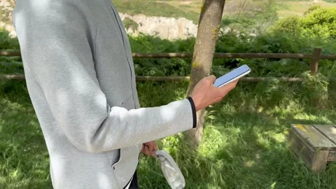 Close up view of male hands using smartphone scrolling, browsing, surfing Stock Footage 242113157