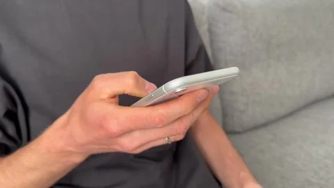 Close up view of male hands using smartphone scrolling, browsing, surfing Stock Footage 242348360