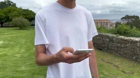 Close up view of male hands using smartphone scrolling, browsing, surfing Stock Footage 245916516