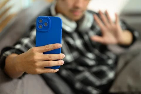 Close up view of male hands using smartphone taking selfie while sitting on Stock Photos