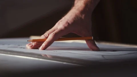 Close up view of male hands working on a building design plan, doing Video stock 105676152