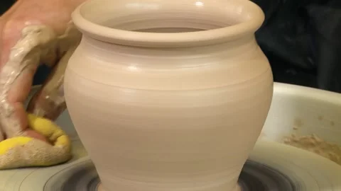 Close view of male hands working with clay on a pottery wheel Stock Footage 133347882