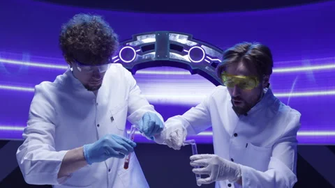 Close-up view of male scientists using laboratory tubes and equipment Stock Footage 240578736