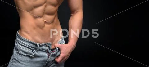 Close up view of male torso in blue jeans and perfect abs Stock Photos